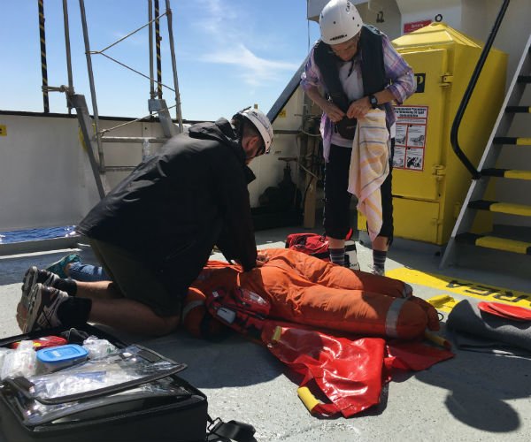 Elizabeth and Connor, the doctor on board, practicing a resuscitation measure