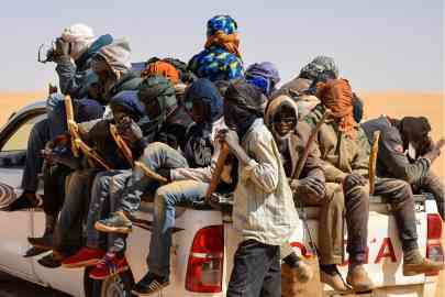 © Souleymane Ag Anara, AFP | File photo: A group of migrant men mainly from Niger and Nigeria sit in the back of a pickup during a journey across northern Niger’s Air desert towards the Libyan border post of Gatrone, January 22, 2019.