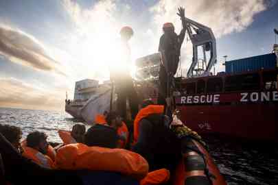 The crew of the Ocean Viking help some of the 128 migrants rescued this weekend on board ship in the central Mediterranean | Photo: SOS Mediterranee X  account @SOSMedIntl
