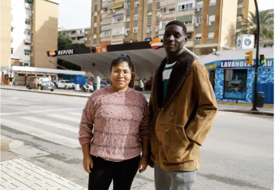 Mansour Konte, a young asylum seeker from Guinea, with Cristina, the woman he had rescued from rising floodwaters. Photo: Screenshot from Sur in English