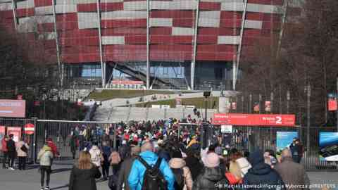 Ukrainians at the national stadium in Warsaw where a center is helping refugees get coveted national identity numbers | Photo: Reuters/Maciek Jazwiecki