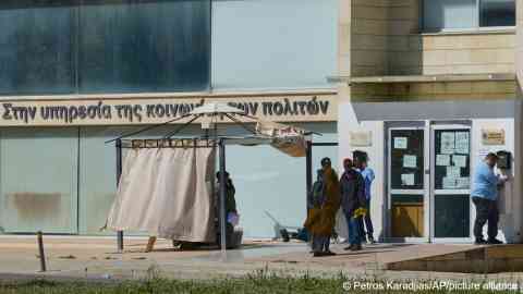 File photo: Migrants are shown waiting outside an immigration department building in the Cypriot capital Nicosia in March 2025 | Photo: Petros Karadjias /AP Photo