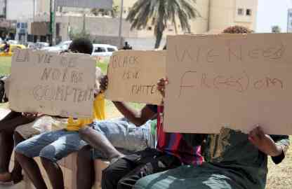 AP | FILE - Migrants hold placards reading "Black Lives Matter", left, in French, during a gathering in Sfax, Tunisia's eastern coast, on 7 July, 2023.