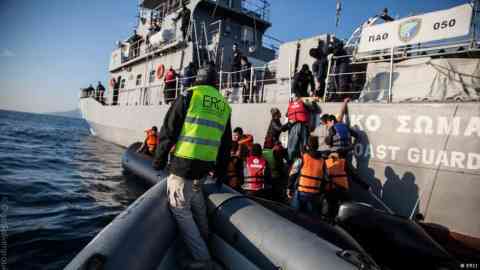 From file: Migrants board a boat with the help of workers from Emergency Response Centre International which operated between 2016 and 2018 | Photo: ERCI