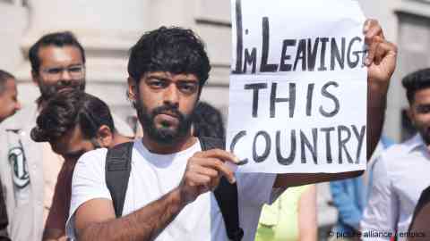 One of several hundred people protesting outside the Irish Prime MInister's office in Ireland on Wednesday (August 13) against a spate of racis attacks perpetrated against South Asian migrants | Photo Niall Carson/PA Wire / empics