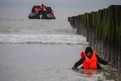 © AFP/Bernard Barron | A migrant returns to shore after attempting to cross the English Channel to reach Great Britain on a smuggler's inflatable dinghy at Sangatte beach near Calais, northern France, on 15 January, 2025. 