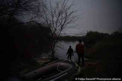 From file: Migrants walk under moonlight next to an inflatable boat before attempting to enter Greece from Turkey by crossing the Evros river | Photo: Felipe Dana/AP Photo