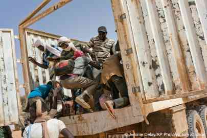 From file: Migrants climb into a truck to head north into Algeria at the Assamaka border 
post in northern Niger | Photo: Jerome Delay/AP Photo 
