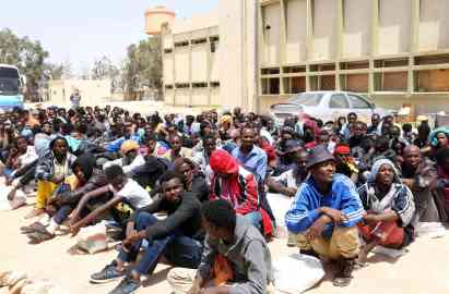 African migrants sit in a facility for irregular migrants in the al-Karem district in Misrata, east of Tripoli, waiting to be transported to a different detention center | Photo: EPA/STR