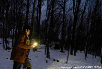 From file: A migrant navigates snow in the forest in Bosnia in 2021 | Photo:Kemal Softic / picture alliance / Associated Press
