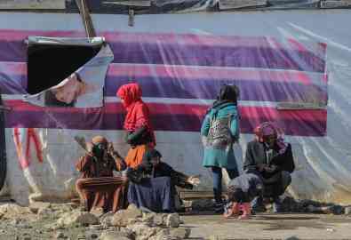 From file: Syrians refugee families sit in the sun in front of their tents in Gazza village in the Beqaa valley, Lebanon. | Photo: EPA/NABIL MOUNZER