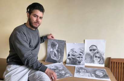 Daniel* (name changed) from Iraq with his pencil drawings; he is currently detained in the Kybartai camp in Lithuania | Photo: Gabriela Ramírez