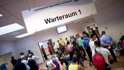 Asylum seekers line up at a government office in Germany | Photo: Imago/IPON