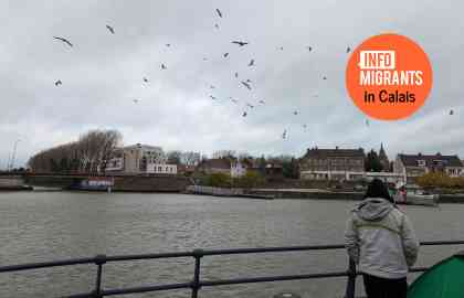 A young man looks out over the Canal in central Calais | Photo: Natasha Mellersh