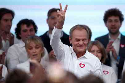 Donald Tusk, leader of the largest opposition grouping Civic Coalition (KO), gestures after the exit poll results are announced in Warsaw, Poland, October 15, 2023.