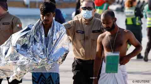 File photo: A Maltese Detention Services Officer escorts some of the 61 migrants rescued off Malta after their boat capsized on December 12 | Photo: Darrin Zammit Lupi / Reuters