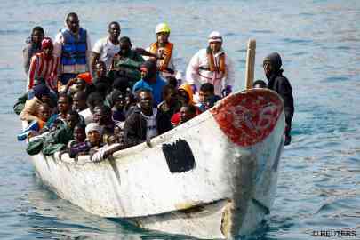File photo: Some of the recent arrivals on the Canary Islands wait to disembark from their boat on Gran Canaria | Photo: Borja Suarez / Reuters