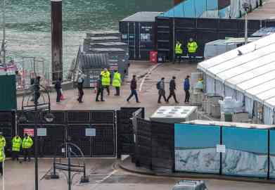 Photo: People are escorted ashore after being picked up in the English Channel at Dover Docks on 26 November 2022 | Photo: EPA/STUART BROCK