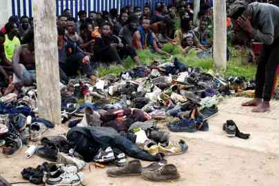 Several migrants resting after they managed to reach Spain by climbing over the border fence with Morocco in Melilla, a Spanish enclave in North Africa. | PHOTO/ARCHIVE/EPA/PAQUI SANCHEZ