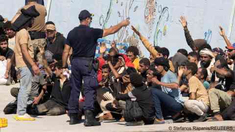 Migrants talk with the authorities, after Greece rescued hundreds of migrants off the islands of Gavdos and Crete in separate incidents, according to the Greek Coast Guard, in the port of Agia Galini, Greece, July 6, 2025. Photo: Stefanos Rapanis / Reuters