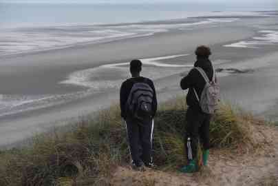 From file: Two Sudenese migrants looking at a beach in Slack, northern France, from where many migrants attempt to reach England via the Channel. Picture date September 8, 2021 | Photo: Mehdi Chebil/InfoMigrants