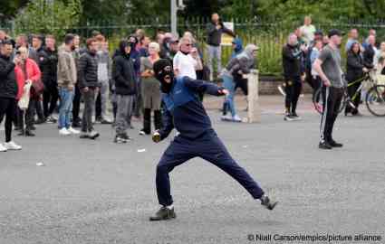 A youngster throws a bottle during protests and violence in north Dublin on Monday | Photo: Niall Carson / empics / picture alliance