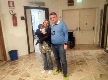 This picture shows Ismail in the arms of Alessandra Teresi, an emergency care doctor in Palermo alongside adjunct deputy police chief Francesco Sammartino | PHOTO: ANSA/CONCETTA RIZZO