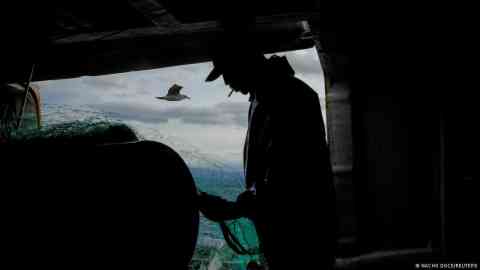 A migrant worker on board a Spanish fishing boat | Photo: Nacho Doce / Reuters