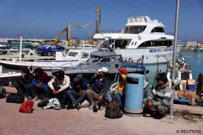 File photo: Migrants wait at a fishing shelter in Paralimni after arriving in Cyprus, April 5, 2024 | Photo: Reuters / Yiannis Kourtoglou