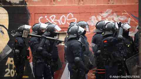 Police prepare to carry out an eviction at the abandoned school buildings | Photo: Albert Gea / Reuters