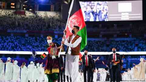 Flag bearers Kimia Yousofi and Farzad Mansouri lead the Afghani team at the opening of the Tokyo Olympics before the Afghan Taliban took power | Photo: Matthias Hangst/Getty Images
