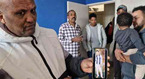 The father of a 16-year-old boy who died in the October 3, 2013, shipwreck off Lampedusa, is displaying his son's photo on his cell phone. The teen was identified by doctors from LUBANOF, the Anthropological and Odontological Lab of Milan's State University. In addition, Orthodox priest Derar Gaim Gebremedhin and Yohans Fishaion, a 20-year-old student, were also identified. They were all Eritrean citizens. Agrigento, January 26, 2026 | Photo: ANSA / CONCETTA RIZZO