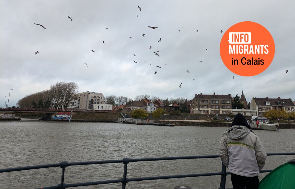 A young man looks out over the Canal in central Calais | Photo: Natasha Mellersh