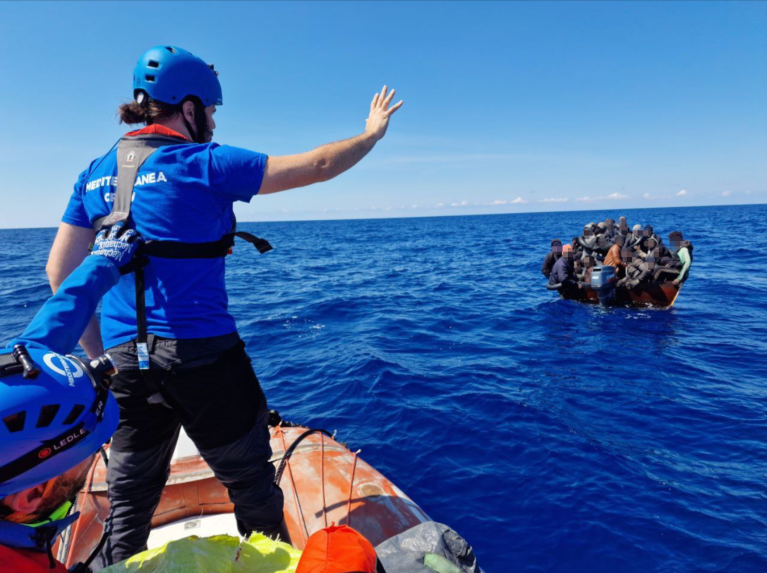 A crew member from the Mare Jonio helps the Italian coast guard rescue 59 people from a metal boat south of Lampedusa on Saturday | Photo: Mediterranea Saving Humans press release www.mediterranearescue.org